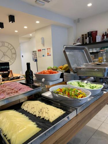 a buffet line with different types of food on display at The G Hotel by JL in St Julian's
