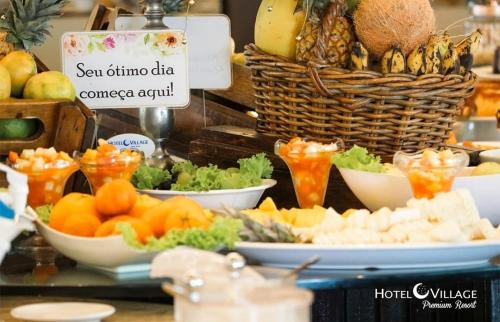 a buffet of fruits and vegetables on a table at Hotel Village Premium Campina Grande in Campina Grande