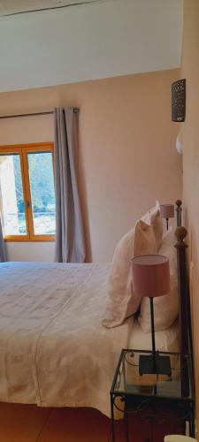 a bedroom with a bed and a glass table at Le Mas des Vergers in Salon-de-Provence