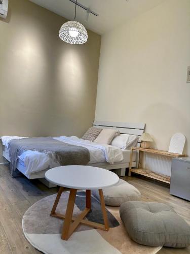 a bedroom with a bed and a white table at 山有巷宅 Alley House in Puli