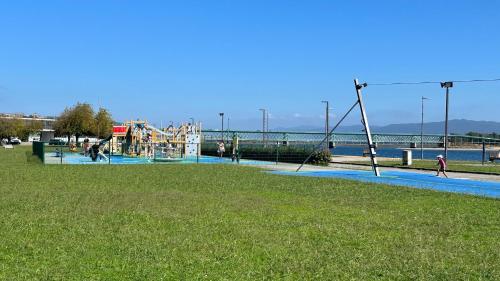 a playground in a park next to the water at FERREIRA'S HOUSE Viana do Castelo in Viana do Castelo