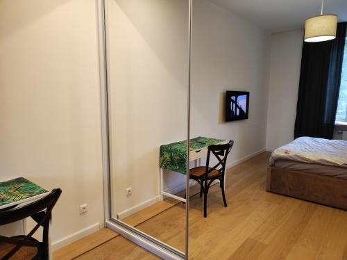 a room with a mirror and a table and a bed at Lux apartment, near metro Vasylkivska in Kyiv