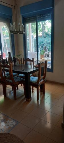 a dining room with a wooden table and chairs at Villa Norte in Ma‘yan Barukh