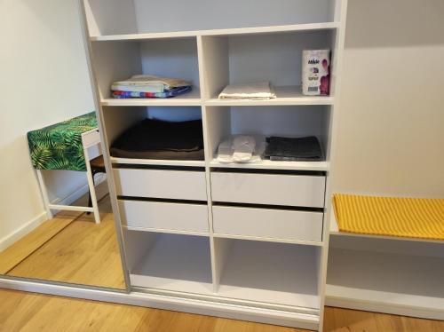 a white bookcase with white shelves in a room at Lux apartment, near metro Vasylkivska in Kyiv