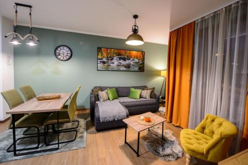 a living room with a couch and a table at Central green in Divčibare