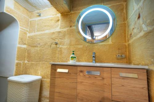 a bathroom with a sink and a mirror on the wall at 1bedroom-stunning views in Valletta center JSPI1-1 in Valletta