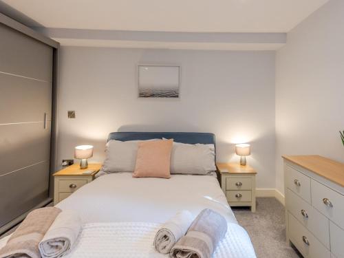 シュルーズベリーにあるPass the Keys Amaranth Stylish town centre apartmentの大きなベッドと2つのナイトスタンドを備えた寝室