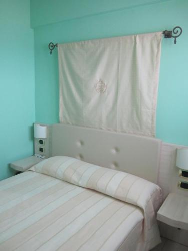 a bedroom with a bed with a towel on the wall at Palazzo Reginella in Bovalino Marina