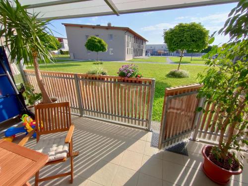 a patio with a fence and a table and chairs at Apartma Velesa in Rače