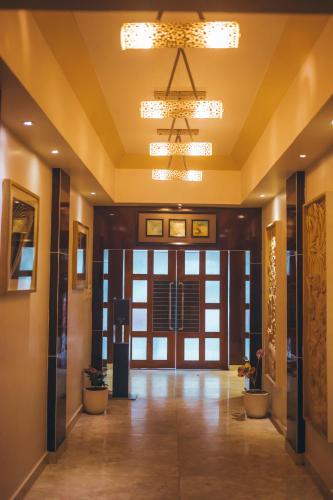 a hallway of a building with a door and a chandelier at KRC Annexe Tezpur in Tezpur