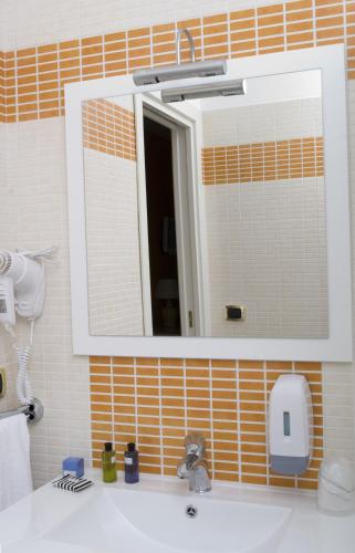 a bathroom with a sink and a mirror at Palazzo Reginella in Bovalino Marina