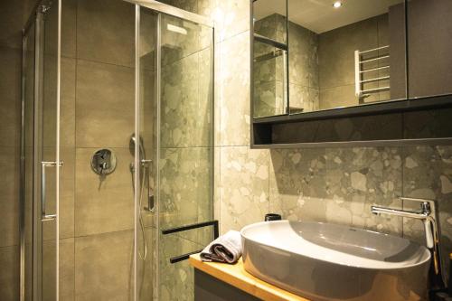 a bathroom with a sink and a shower at CENTRAL OLD TOWN- LADADIKA APARTMENT in Thessaloniki