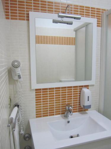 a bathroom with a white sink and a mirror at Palazzo Reginella in Bovalino Marina