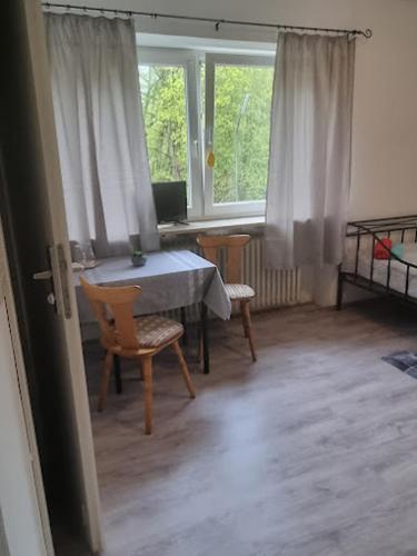 a room with a table and chairs and a window at Gasthaus Weigl in Großmehring