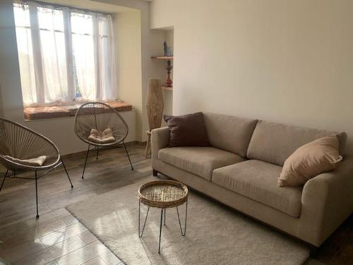 a living room with a couch and two chairs at Du Vent Dans Les Arbres -120m2 Belle vue sur le lac in Chindrieux