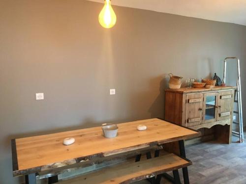 a room with a wooden table and a wooden cabinet at Du Vent Dans Les Arbres -120m2 Belle vue sur le lac in Chindrieux