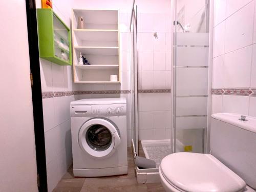 a bathroom with a washing machine and a toilet at Tropicalidays Paraiso del Sur in Adeje