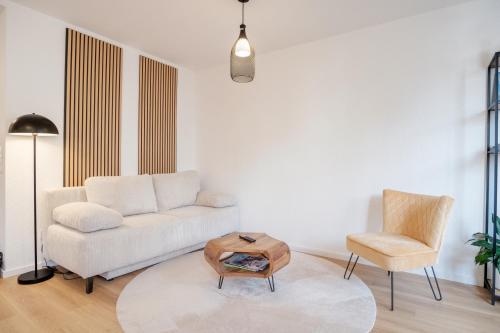 a living room with a couch and a chair at Neues Design-Apartment, Altstadt, Business&Ferien, Küche, Netflix in Bad Säckingen