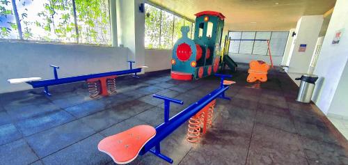 a childrens play room with a train and benches at Atlantis Residence Melaka by YouBNB Homestay in Melaka