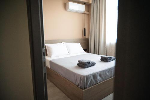 a bedroom with a bed with two towels on it at CENTRAL OLD TOWN- LADADIKA APARTMENT in Thessaloniki