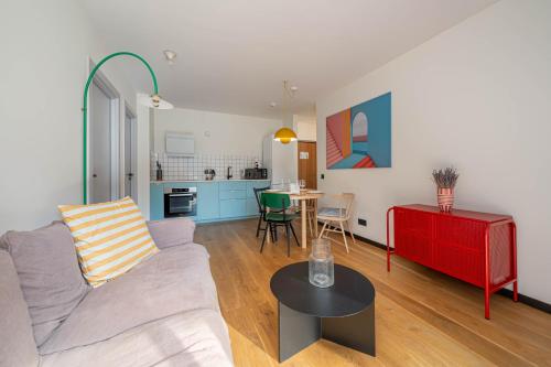 a living room with a couch and a table at Stylish 2-Bedroom With Large Terrace, Near Forest Park & Beach, Child-Friendly Location in Jūrmala
