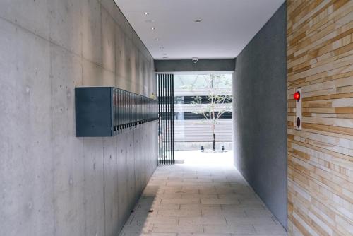 a hallway of a building with a wall with a staircase at REST COLLECTION Kujo Osaka in Osaka