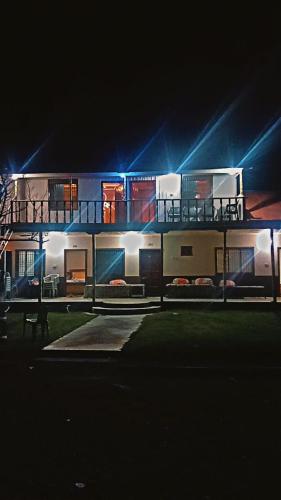 a large building with lights on it at night at Northern Huts And Riverview Restaurant in Bālākot