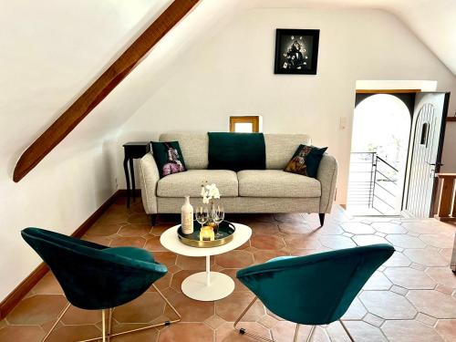 a living room with a couch and chairs at Gîte Fancy, Vallée du Scorff, Nature 2-4 personnes in Arzano