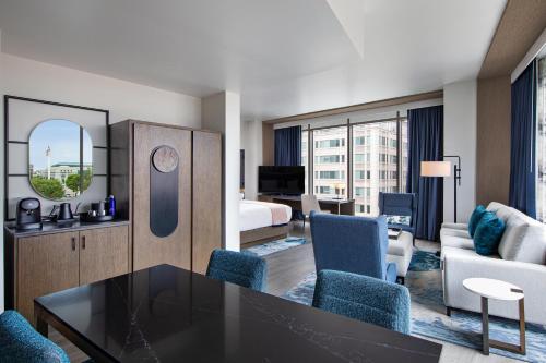 a hotel room with a table and a bedroom at The Royal Sonesta Washington DC Capitol Hill in Washington