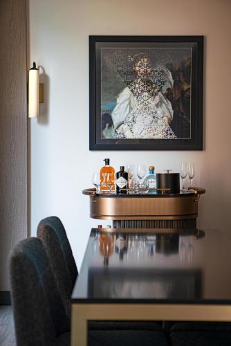a dining table with two chairs and a painting on the wall at The Royal Sonesta Washington DC Capitol Hill in Washington