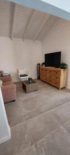 a living room with a flat screen tv and a couch at Morning Star Aruba in Oranjestad