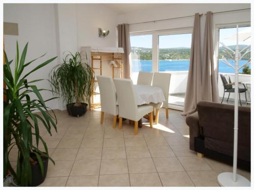 a dining room with a white table and chairs at The Peninsula in Primošten