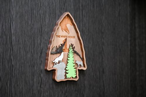 a wooden pin with a picture of a forest at The White Horse Apartmens in Borovets
