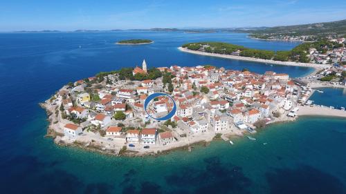 an island in the water with a blue circle on it at The Peninsula in Primošten