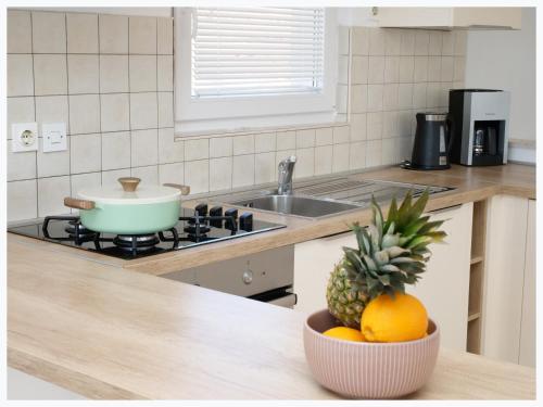 a kitchen with a bowl of fruit on a counter at The Peninsula in Primošten