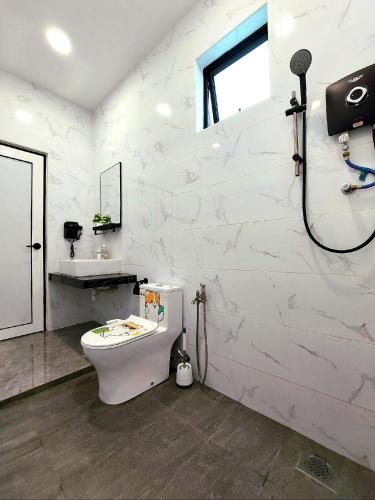 a white bathroom with a toilet and a shower at Good2Stay Villa 15-20pax I 4R4B 1KTV I Swimming Pool I BBQ I Gaming I 10 Parking I Wifi6 in Malacca