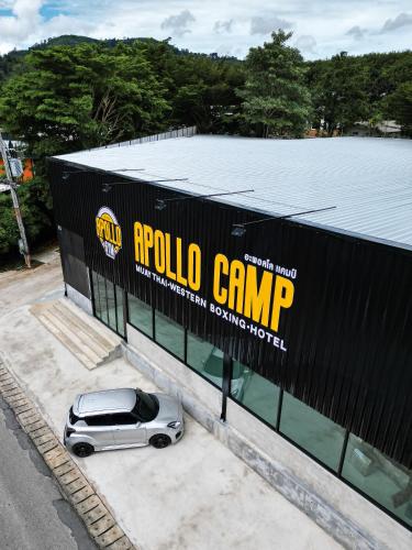 a car parked on the side of a building at Apollo Hotel Chalong in Ban Suan