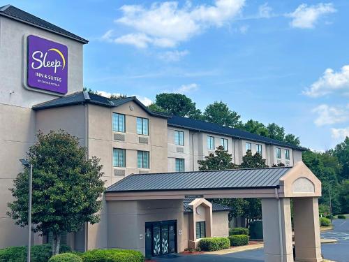 a hotel with a sign on the front of it at Sleep Inn & Suites Near Columbus - State University Area in Columbus