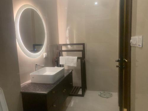 a bathroom with a sink and a mirror at Luxury Penthouse with Taj Mahal view in Agra