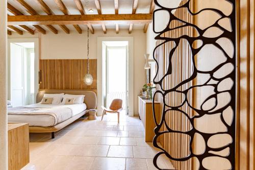 a bedroom with a bed and a desk in a room at Pollicastro Boutique Hotel in Lecce