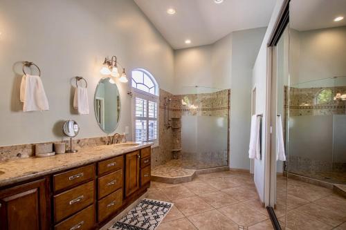 a bathroom with a shower and a sink and a mirror at Desert Canyon Retreat W Heated Pool & Desert View in Phoenix