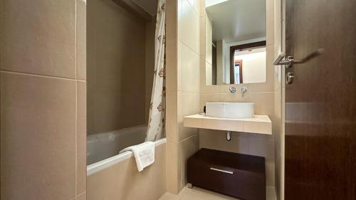 ein Badezimmer mit einem Waschbecken und einer Badewanne in der Unterkunft Herdade dos Salgados, T2 12C 3D, Vila das Lagoas in Albufeira