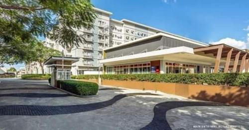 a large building in front of a building at Chelsea Suite's Esthetic Staycation at Trees Residence QC in Manila