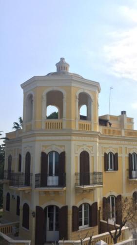 a large yellow building with a balcony at Villa Giada in Trani