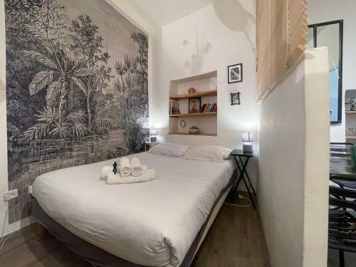 a bedroom with a large bed with towels on it at Modern Apartment Nice Old Town in Nice