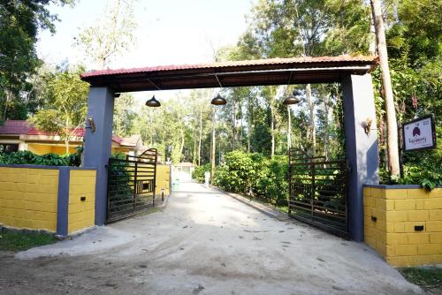 an entrance to a farm with a gate at RICHBERRY- A Premium Plantation Villa's in Suntikoppa