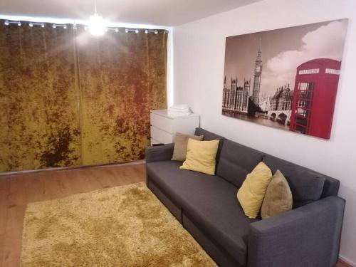a living room with a couch and a red phone booth at Self contained 2 Bedroom flat in Southwark in London