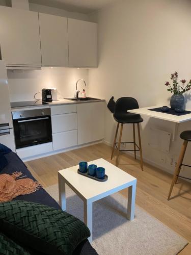 a living room with a couch and a table at Nordheim Studio Apartment in Tromsø