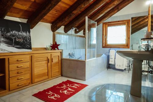 a bathroom with a shower and a sink and a tub at Chaletbethere in Pila