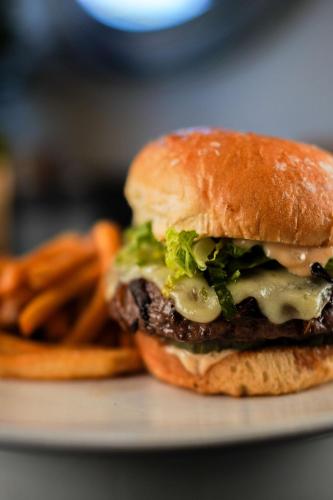 a cheeseburger on a plate with french fries at Waldorf Astoria Chicago in Chicago